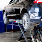 Black car on mechanical lift